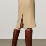 Back view of naturale rugaida skirt on model wearing ls shirt and boots, against a white background.