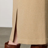 Side closeup view of naturale rugaida skirt on model wearing boots, against a white background.