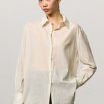 Front view of milk selma classic shirt on model wearing green pants, against a white background.