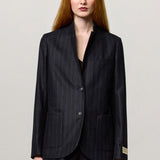 Front view of blu stromboli blazer on model wearing blu pants and brown top, against a white background.