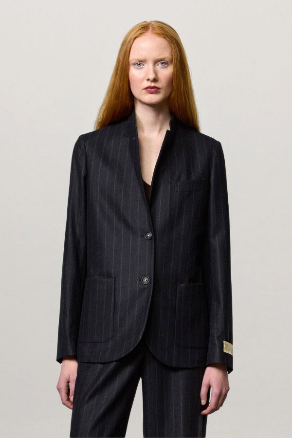Front view of blu stromboli blazer on model wearing blu pants and brown top, against a white background.