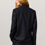 Back view of blu stromboli blazer on model wearing blu pants, against a white background.