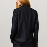 Back view of blu stromboli blazer on model wearing blu pants, against a white background.