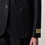 Front closeup view of blu stromboli blazer om model wearing blu pants, against a white background.