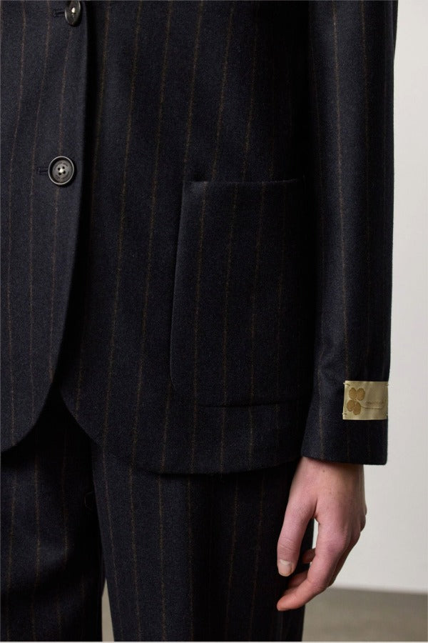 Front closeup view of blu stromboli blazer om model wearing blu pants, against a white background.
