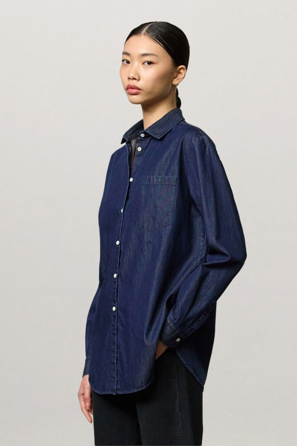 Front view of blue uma classic shirt on model wearing black pants, against a white background.