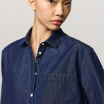 Front closeup view of blue uma classic shirt on model, against a white background.
