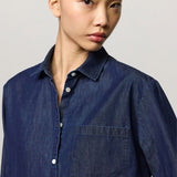 Front closeup view of blue uma classic shirt on model, against a white background.