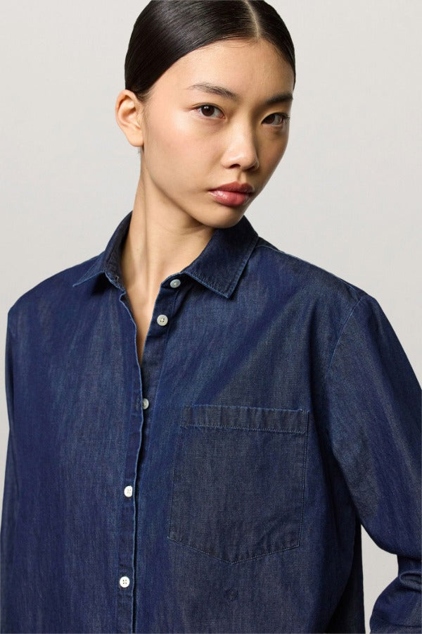 Front closeup view of blue uma classic shirt on model, against a white background.