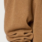 Side closeup view of cannella valentina v-neck sweater on white background, with no model shown.