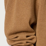 Side closeup view of cannella valentina v-neck sweater on white background, with no model shown.