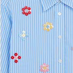 Front closeup view of blue/white button embroidered cropped shirt on white background, with no model shown.