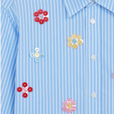 Front closeup view of blue/white button embroidered cropped shirt on white background, with no model shown.