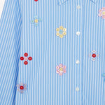 Front closeup of blue and white button embroidered ls shirt dress on white background, with no model shown.
