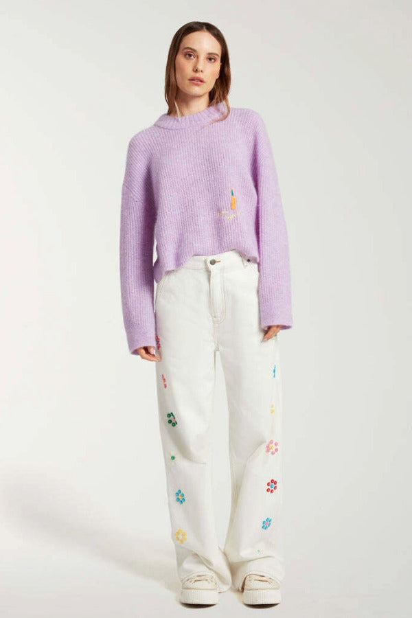 Front view of white straight leg jean on model wearing purple sweater and white sneakers, against a white background.