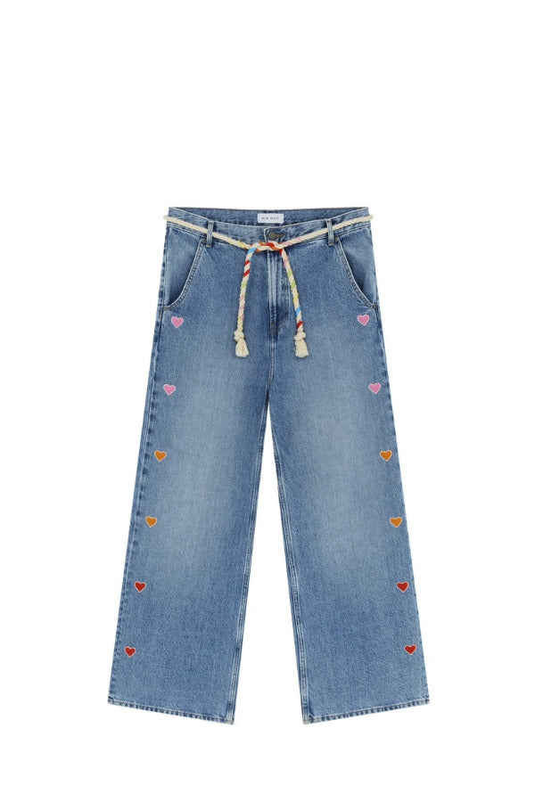 Front view of mid blue embroidered straight leg jean on white background, with no model shown.