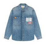 Front view of mid blue embroidered word patch denim overshirt on white background, with no model shown.