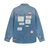 Back view of mid blue embroidered word patch denim overshirt on white background, with no model shown.
