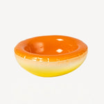 Front view of orange hand sprayed ombre bowl on white background, with no model shown.