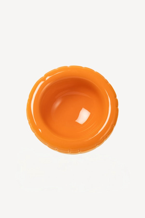 Overhead view of orange hand sprayed ombre bowl on white background, with no model shown.