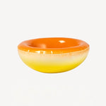 Alternate front view of orange hand sprayed ombre bowl on white background, with no model shown.