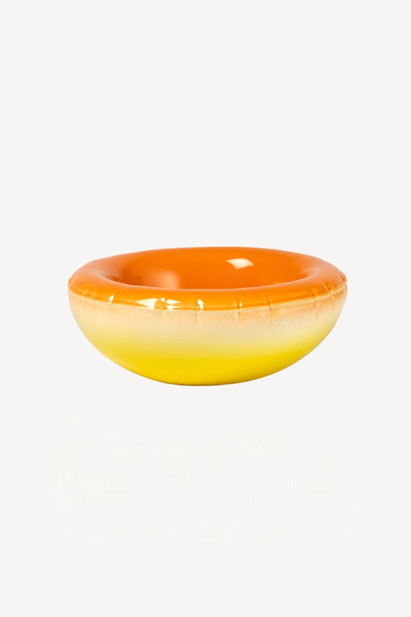 Alternate front view of orange hand sprayed ombre bowl on white background, with no model shown.