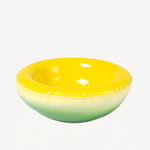 Front view of yellow hand sprayed ombre bowl on white background, with no model shown.