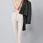 Front view of beige striped universal pant on model wearing grey bra and loafers, against a grey background.