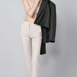 Front view of beige striped universal pant on model wearing grey bra and loafers, against a grey background.