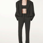 Front view of black the jacket on model wearing black pants and heels, against a white background.