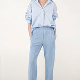 Alternate front view of blue the shirt on model wearing blue pinstriped pants, against a white background.