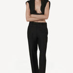 Front view of black unisex pant on model wearing open black sweater, against a white background.