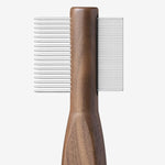 Side view of combing tool form Pansage grooming kit on white background, with no model shown.