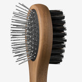 Side view of brush tool from Pansage grooming kit on white background, with no model shown.
