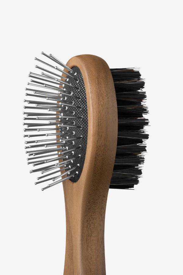 Side view of brush tool from Pansage grooming kit on white background, with no model shown.