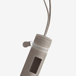 Front view of taupe the pouchette dog bag holder on white background, with no model shown.