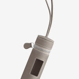 Front view of taupe the pouchette dog bag holder on white background, with no model shown.