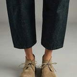Front view of pair of sand antoine desert boots on model wearing cropped jeans, against a white background.
