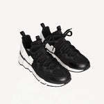 Front slanted view of black/white calf/canvas trek comet sneakers on white background, with no model shown.