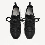 Overhead view of black/white calf/canvas trek comet sneakers on white background, with no model shown.