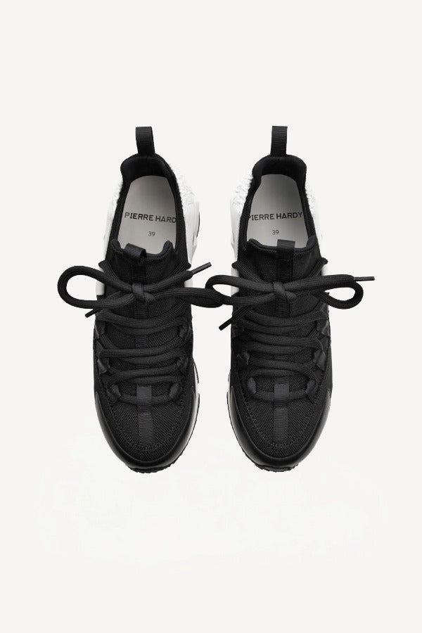 Overhead view of black/white calf/canvas trek comet sneakers on white background, with no model shown.