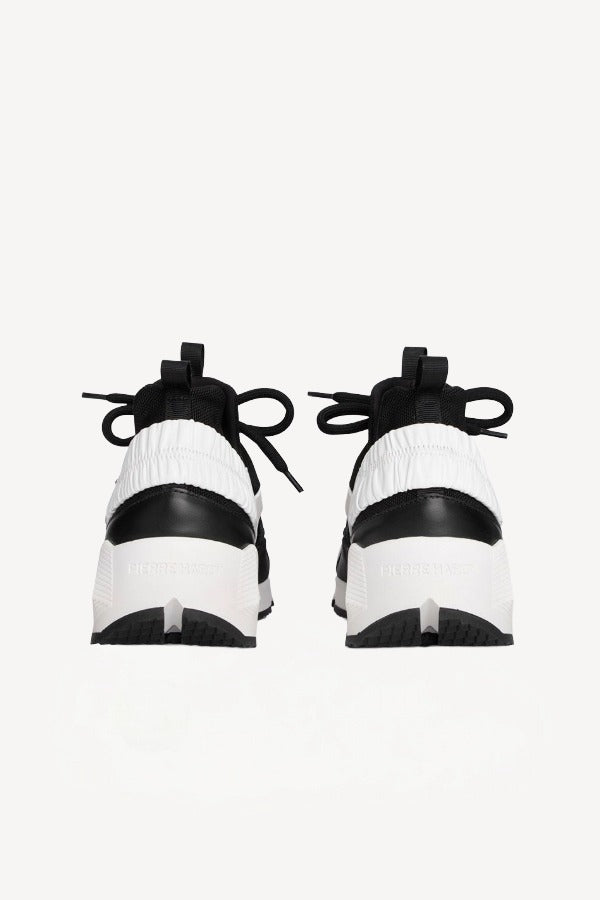 Back view of black/white calf/canvas trek comet sneakers on white background, with no model shown.