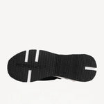 Sole view of black/white calf/canvas trek comet sneaker on white background, with no model shown.