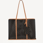 Front view of black/tan canvas cube and calf cab tote on white background, with no model shown.