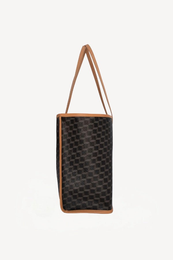 Side view of black/tan canvas cube and calf cab tote on white background, with no model shown.