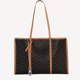 Back view of black/tan canvas cube and calf cab tote on white background with no model shown.