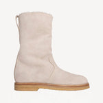 Right side view of off white montana suede and sherling ankle boot on white background, with no model shown.