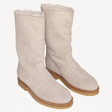 Front slanted view of off-white montana suede and sherling ankle boot on white background, with no model shown.