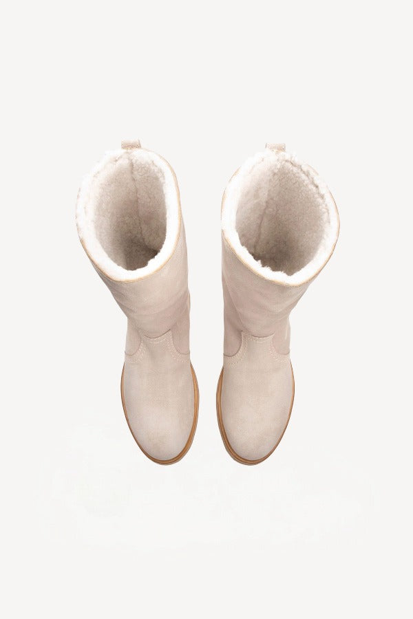Overhead view of off-white montana suede and sherling ankle boot on white background, with no model shown.