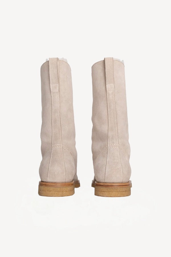 Back view of off-white montana suede and sherling ankle boot on white background, with no model shown.